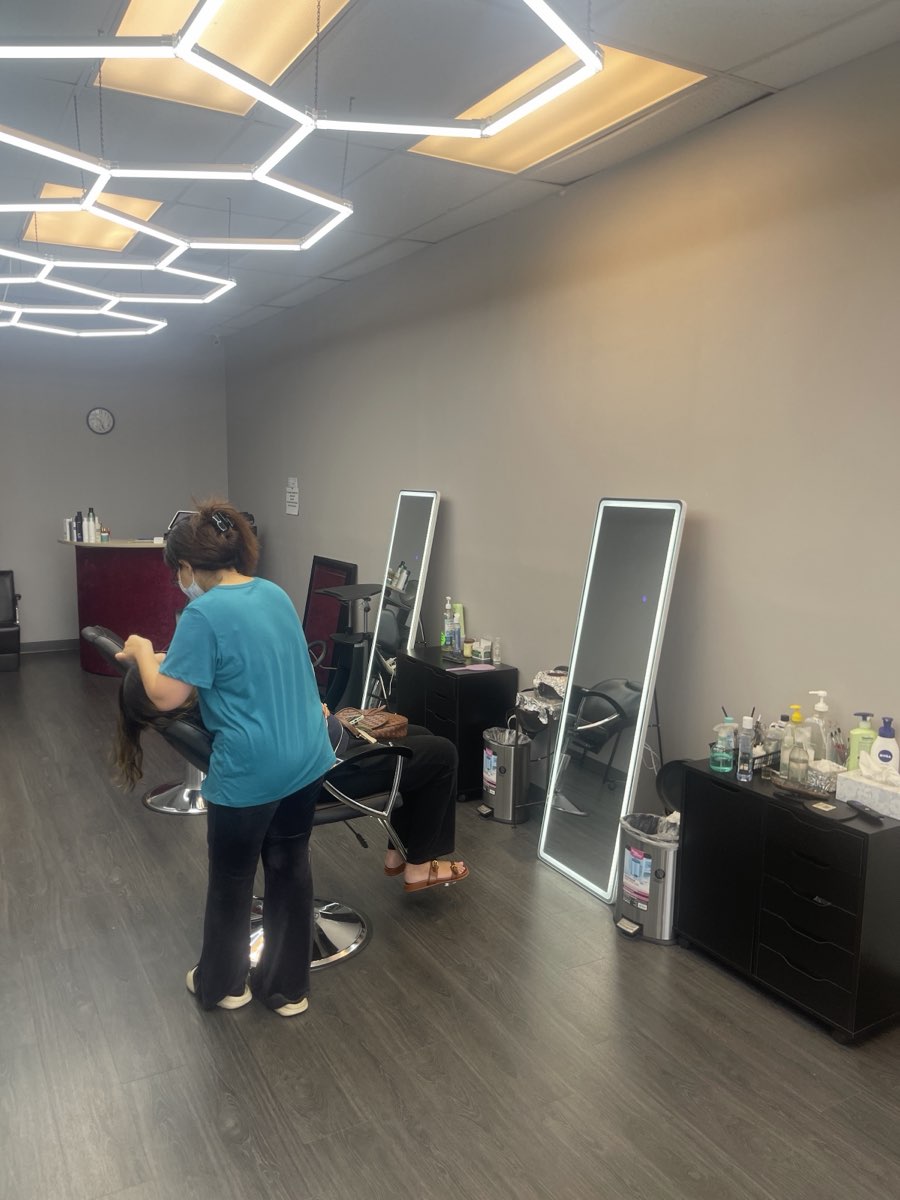Inside Looks Beauty Salon, a stylist at work under the studio's bright lighting