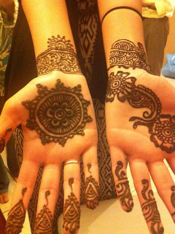 Detailed henna artwork on both hands